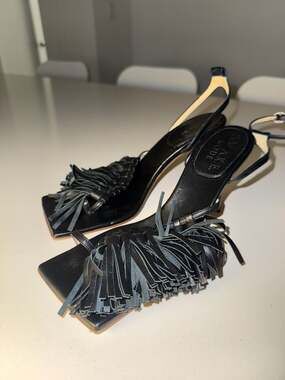 A.W.A.K.E. MODE Delta Black Tassel High Heel Sandals